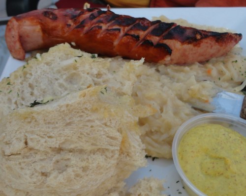 Polish Style Grilled Keilbasa with fried sauerkraut, onions, and garlic bread